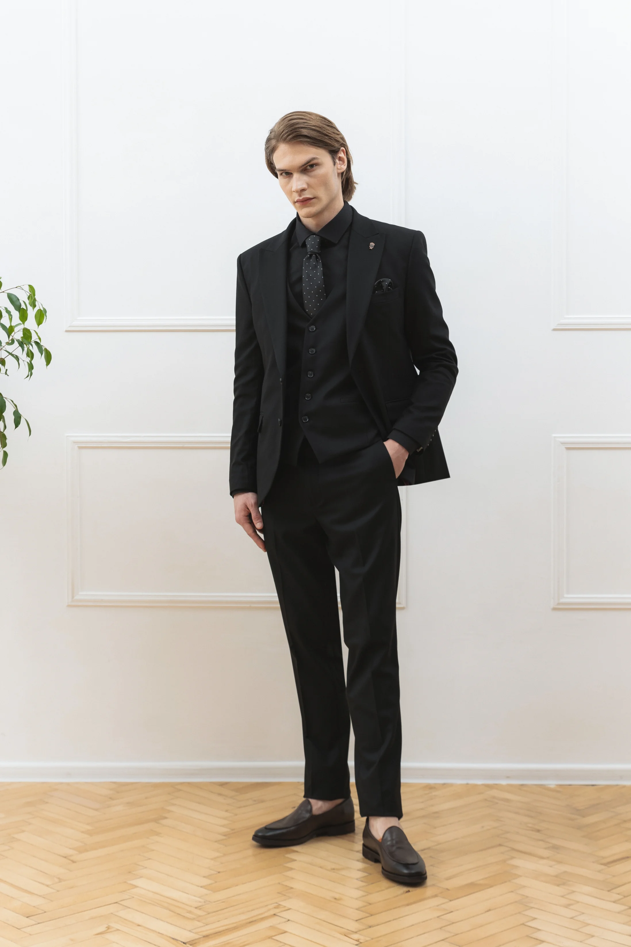 Men's three-piece wool suit in black with peak lapel