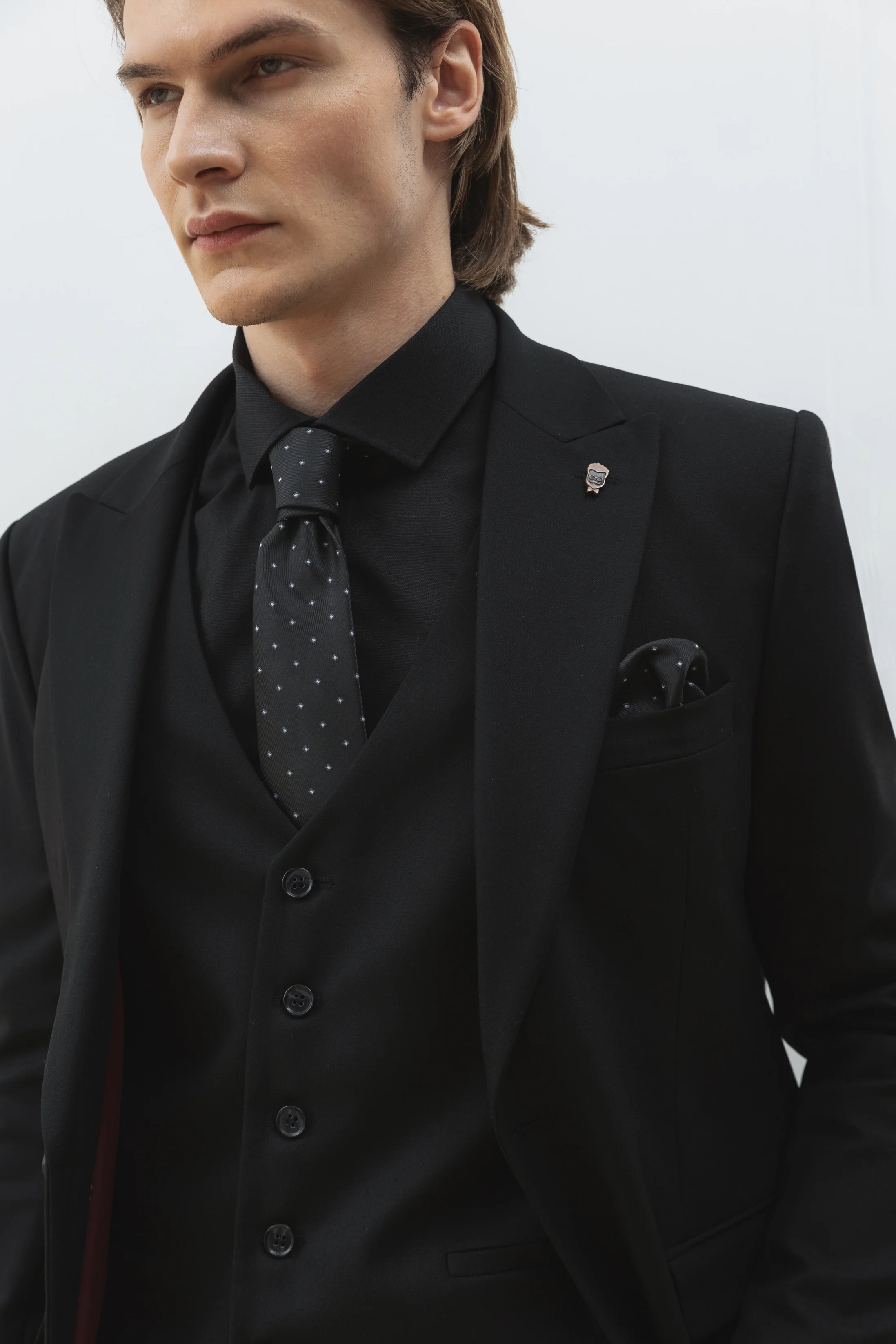 Men's three-piece wool suit in black with peak lapel